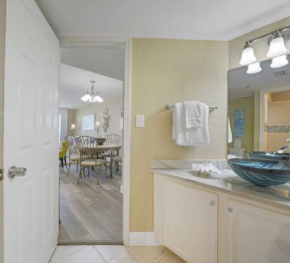 Bright and clean full guest bathroom with marble-look countertops, modern fixtures, and spacious layout for added comfort.