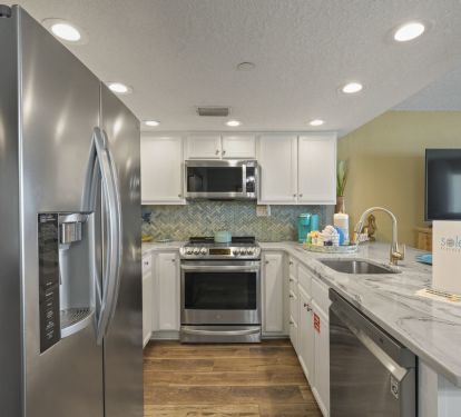 This stunning condo offers a complete kitchen setup with full size appliances, ample prep space that is ideal for guests seeking convenience and comfort.