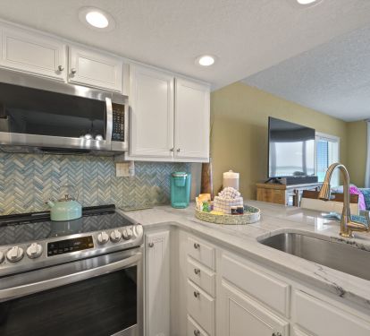Enjoy cooking in this beautifully remodeled kitchen featuring a stainless steel electric range and spacious countertops