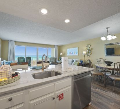 The open concept layout includes a modern kitchen with granite countertops, bar stools for additional seating, and a dining area perfect for morning coffee or family dinners.