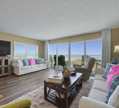 Cabana Club 101-s living room offers plenty of space for family or friends, complete with comfortable seating, entertainment amenities, and unobstructed views of crystal clear waters right outside your balcony doors