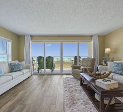 Step into the spacious living room of Cabana Club 101, where queen sleeper sofas and a smart TV face expansive sliding doors showcasing breathtaking Gulf views. Perfect for sunset watching or relaxing after a day on the sugar white sand.