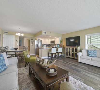 This airy, open concept living room offers direct balcony access with unobstructed ocean views.
