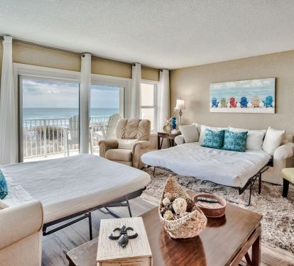 Oceanfront vacation rental featuring bright living space, sleeper sofas, and private Gulf-view balcony.