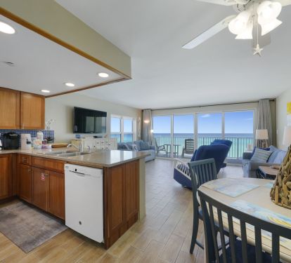 Coastal dining space beside fully equipped kitchen