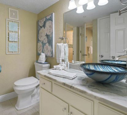 Comfortable guest bath showcasing sleek finishes and contemporary coastal design touches.