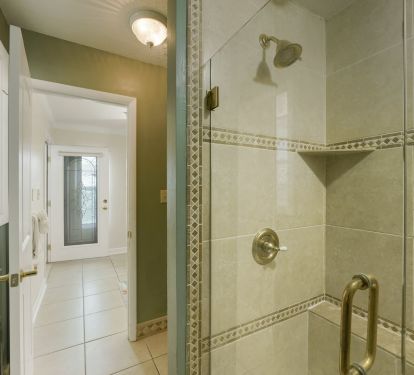 Inviting guest bathroom with coastal d-cor and convenient access to walk-in shower.