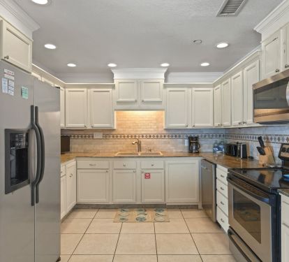 Family-friendly kitchen with ample counter space and seating for gathering after a beach day.