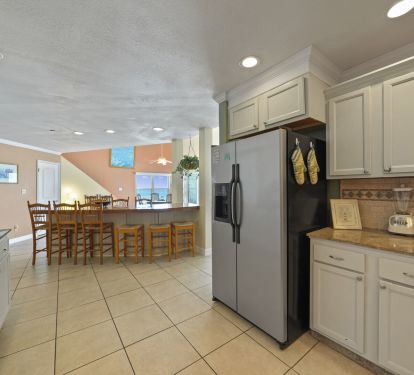 Spacious fully equipped kitchen with breakfast bar in Cabana Club Destin beachfront condo.