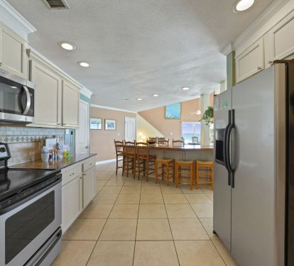 Bright kitchen overlooking dining area with Gulf views in Crystal Beach Destin vacation rental.