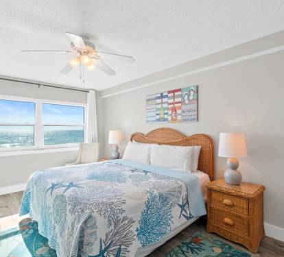 Beautiful bedroom with serene coastal d-cor and plenty of natural light