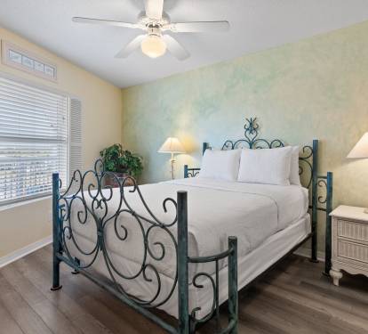 Features a charming wrought-iron bed, side lamps, and a relaxed vibe for restful sleep.