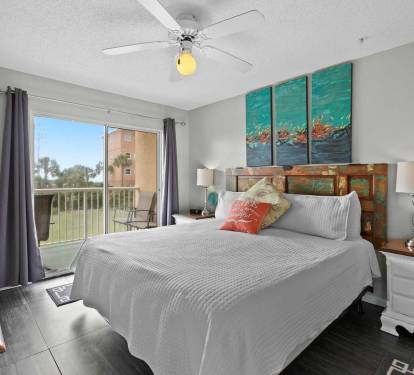 master bedroom with private balcony access, and calming coastal d-cor.
