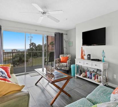 Open and airy living area with balcony access and natural light.