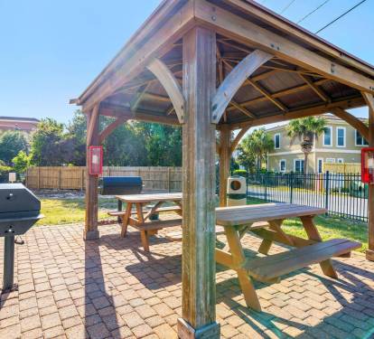 Outdoor picnic pavilion with grills and shaded seating, perfect for cookouts after a day at the beach.