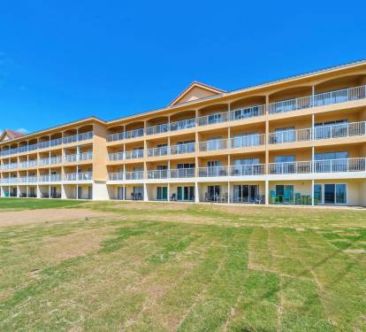Spacious condo complex with private balconies overlooking beautifully maintained grounds