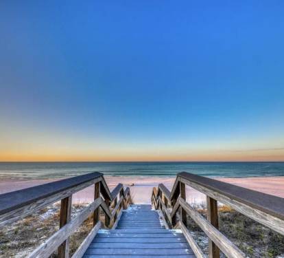Private boardwalk leading straight to sugar-white sand and emerald waters of the Gulf
