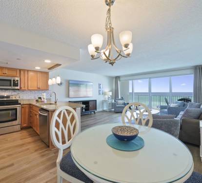 Cabana Club 307 beachfront condo in Destin featuring an open-concept kitchen, dining area, and Gulf-front living room with private balcony overlooking the Emerald Coast.