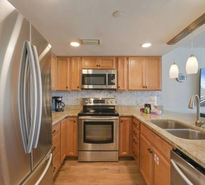 Cabana Club 307 boasts a beautifully updated kitchen with stainless steel appliances, ample counter space, and seating for family gatherings.