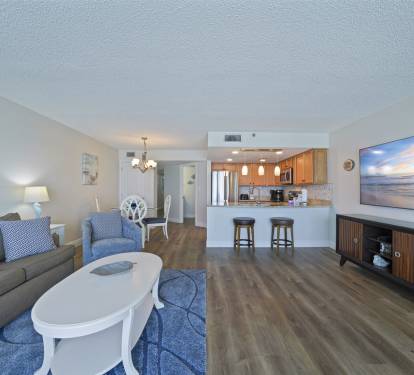 This Destin beachfront condo-s main living area is designed for relaxation, with panoramic ocean views and easy indoor-outdoor living.