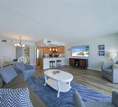 Cabana Club 307 open living and dining area with updated kitchen, bar seating, and comfortable lounge space just steps from the Emerald Coast beach.