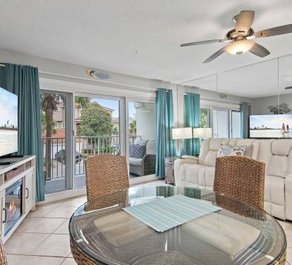 Bright living room with flat-screen TV and balcony access at Maravilla 4205, a Miramar Beach condo rental.