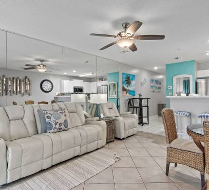 Living room with leather seating, mirrored wall, and coastal d-cor at Maravilla 4205.