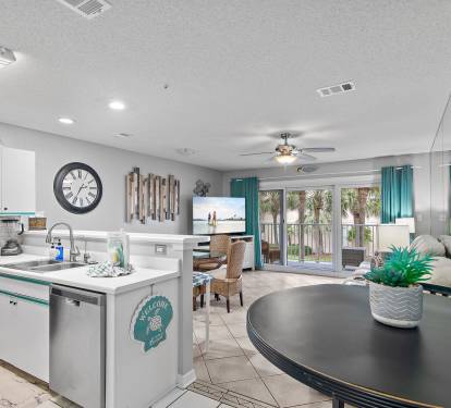 Open kitchen and living area with coastal d-cor and bar seating at Maravilla 4205, a Miramar Beach vacation rental.