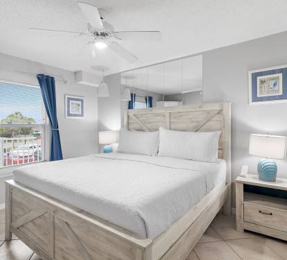 Bedroom with king bed, ceiling fan, and coastal d-cor at Maravilla 4205, a Miramar Beach vacation rental.