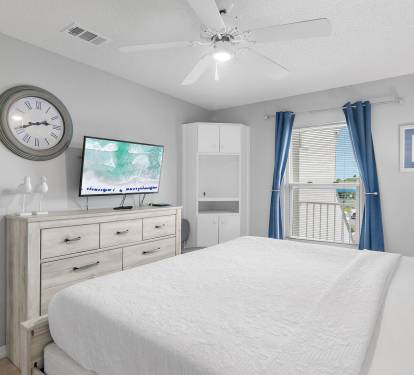 Bedroom with king bed, flat-screen TV, and coastal d-cor at Maravilla 4205, a Miramar Beach vacation rental.