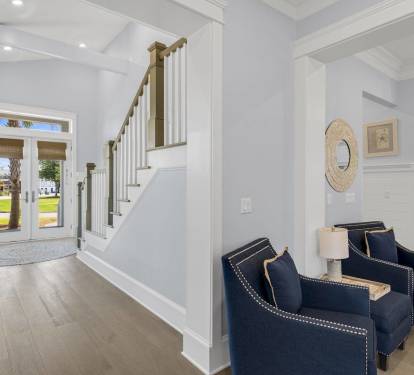 Welcoming entry, elegant staircase, thoughtful details. The moment guests walk in, they know they chose right and they're in a quality home.