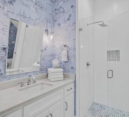 Clean and modern bathroom featuring a glass walk-in shower, updated fixtures, and a bright vanity space.