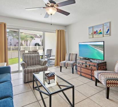 Cozy living room with flat screen T.V. & outside views.