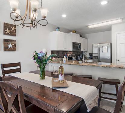 Cozy coastal dining meets modern kitchen comfort - the perfect spot to share meals and memories.