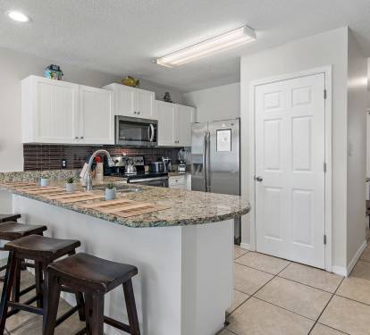 Spacious kitchen with bar seating.