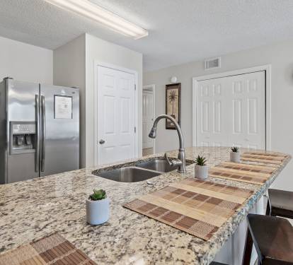 Spacious granite breakfast bar with seating for four - perfect for casual meals and conversation.