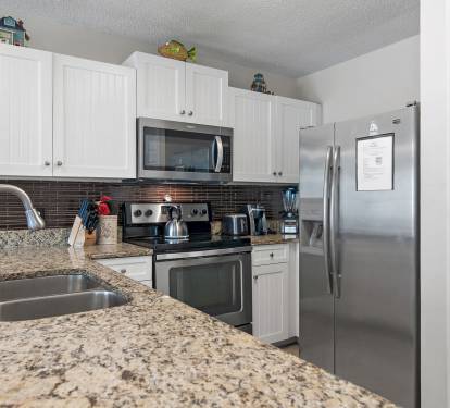 Fully equipped kitchen with stainless steel appliances and plenty of counter space for easy meal prep.