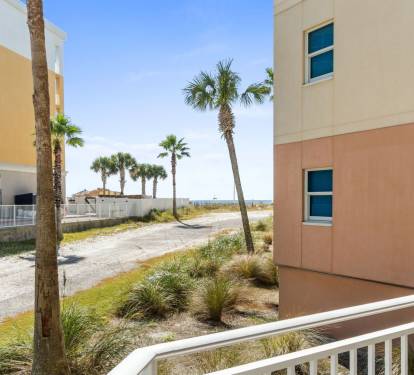 Relax outdoors on your private balcony with views of the pool and Gulf, accessible from both bedrooms and the living area.