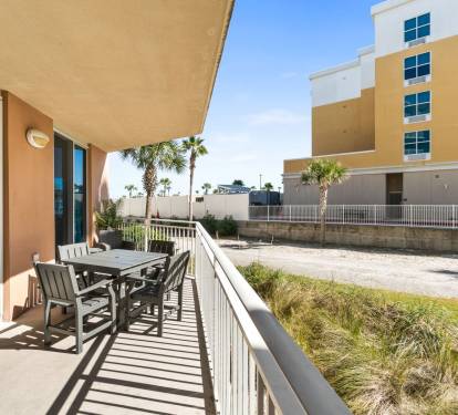 Balcony retreat with seating for relaxing, sipping drinks, and soaking up the sunshine - accessible from all main rooms.