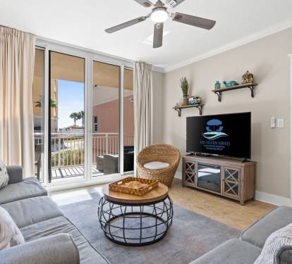 Perfect for family movie nights, this inviting living room offers a Smart TV, sleeper sofa, and doors that open to fresh coastal air.