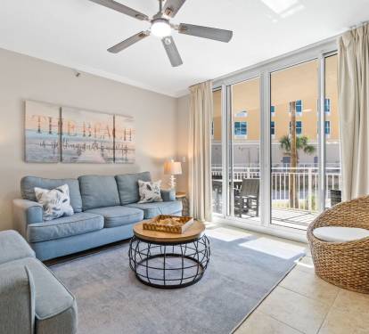Bright and welcoming living area featuring a Smart TV with cable, comfy sleeper sofa, and easy access to the balcony.