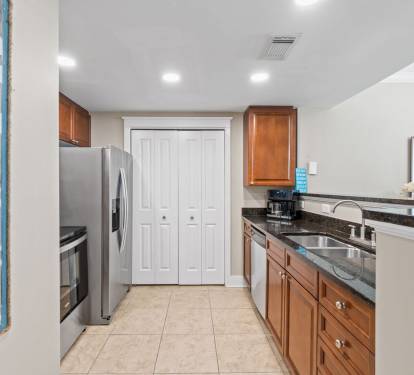 Coastal-style kitchen with all the essentials, open to the dining area and boasting beautiful views toward the balcony.