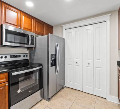 Inviting kitchen space designed for convenience and connection, with full appliances and open access to dining and balcony views.