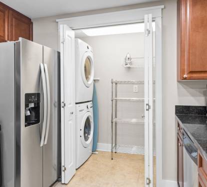 Cook with a view in this fully stocked kitchen that opens to the dining area and offers a peek of the Gulf from the balcony.