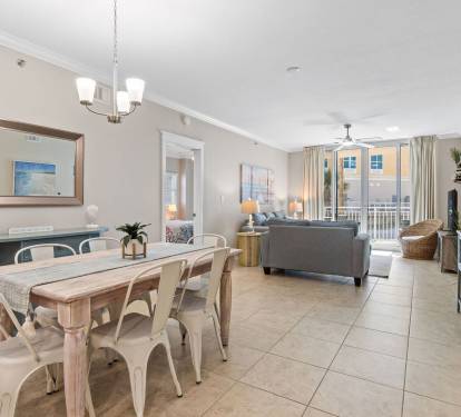 Bright coastal kitchen featuring everything you need to cook and enjoy meals with a view of the balcony and pool.