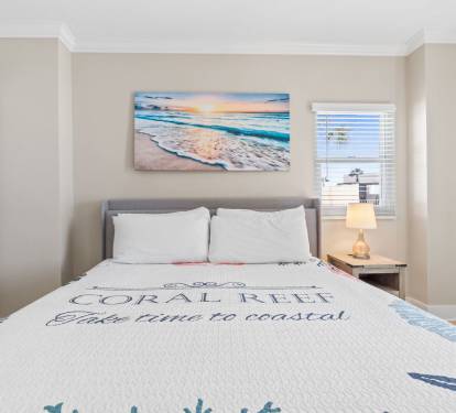 Cozy coastal retreat with a king bed, Smart TV, private bathroom, and balcony access for fresh ocean air.