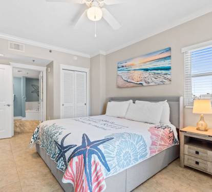 Elegant master bedroom offering a king bed, Smart TV, and attached full bath - linens provided.