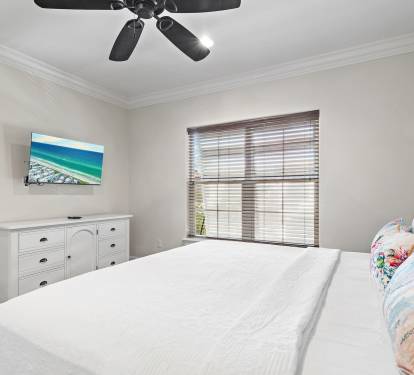 Spacious upstairs retreat with a plush king bed and natural light.