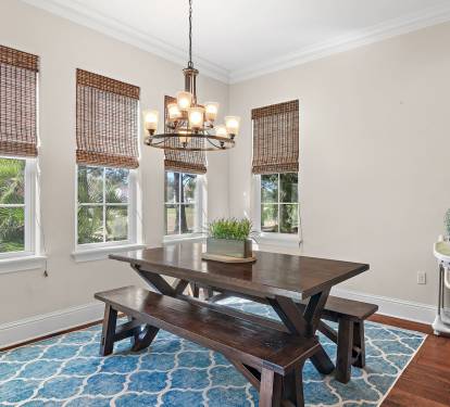 Gather around the dining table surrounded by natural light and peaceful Sandestin views.