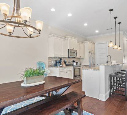 This inviting open-concept space features a beautifully designed kitchen with granite countertops, stainless steel appliances, and ample cabinetry.